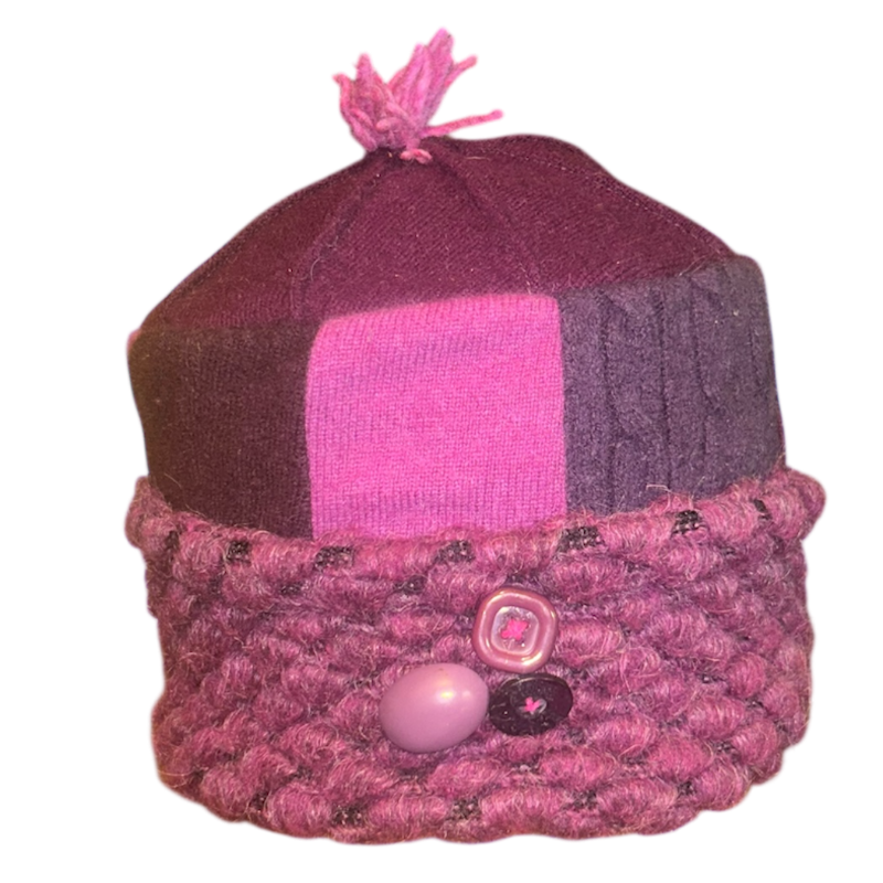 Pink and purple knitted hat with a pom-pom on a white background
